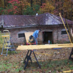 exterior of Shivar Spring Company building with man working in foreground